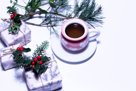 View of a tea mug and Christmas gift or present box wrapped in paper. Gifts tied with ribbon. Background for Christmas,empty space for holiday text.の写真素材