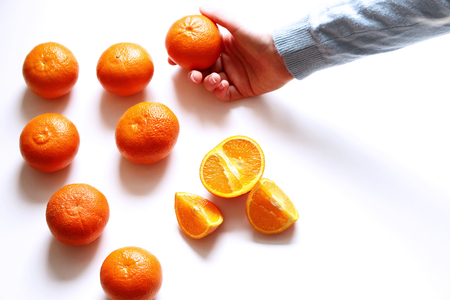 The collection of the fresh mandarins . Juicy mandarins in the woman's hands isolated on white background.Top view,picture design for foods background.の写真素材