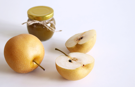 Jar of nashi jam on white wooden background . Delicious fruit . Blurred background.Food and healthy concept.の写真素材