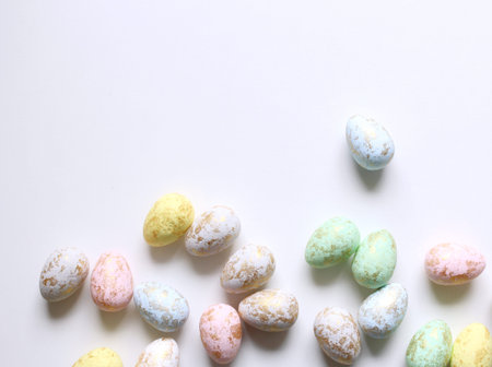 Top view of easter eggs colored with golden paint in differen patterns. Various striped and dotted...