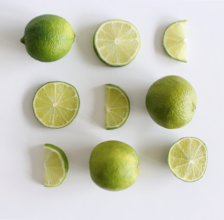 Set of fresh whole and cut lime and slices isolated on white background. From top view. Rich of nutrients, fiber, and vitamins,picture design for foods background.の写真素材