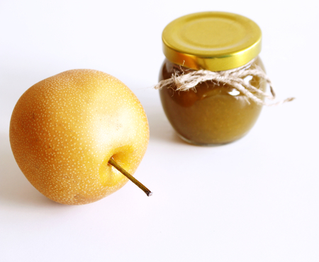 Jar of nashi jam on white wooden background . Delicious fruit . Blurred background,food and healthy concept.の写真素材