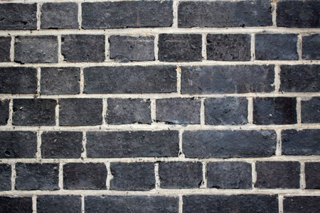 Detail of whitewashed exterior brick wall, for texture and background . Macro detail, industrial pattern.の写真素材