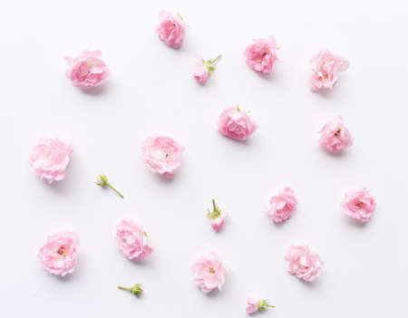 Floral pattern made of pink roses on white background. Flat lay, top view. Valentines background. Floral pattern. The design of flowers. Flowers pattern texture. Nature concept.の写真素材