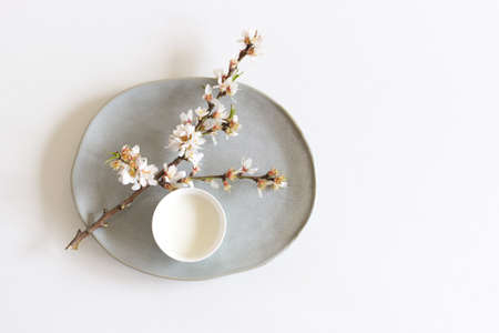 lowering branch of almond and cup of almond milk on a white background.Healthy eating concept.Copy space.の写真素材