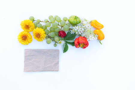 Frame made of autumn flowers, fruits, vegetables and a price tag on white table background. Fall, Halloween, Thanksgiving concept. Styled stock flat lay photography, web banner. Top view. Autumn concept.の写真素材