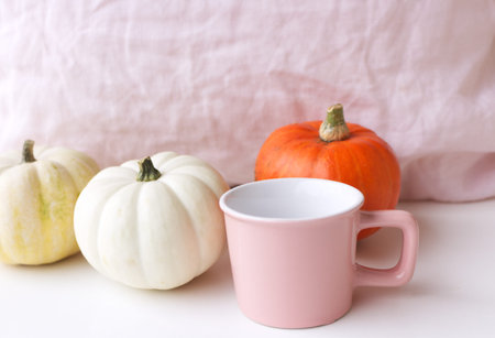 Cozy autumn morning breakfast in bed still life scene. A steaming cup of hot coffee and pumpkins. Fall, Thanksgiving concept.Side view. Autumn concept.の写真素材