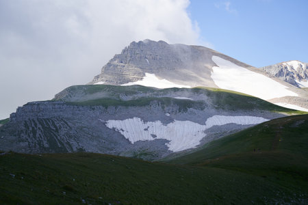 Scenery landscape with mountain partly covered with clouds and snow.の写真素材