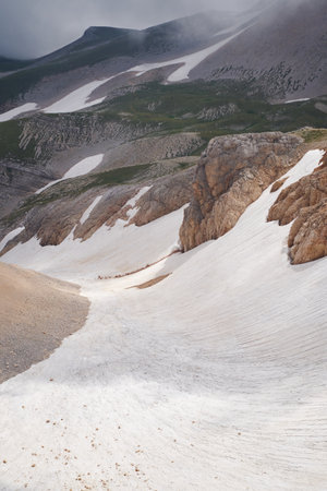 Vertical landscape with a mountain gorge with a melting glacier insideの写真素材