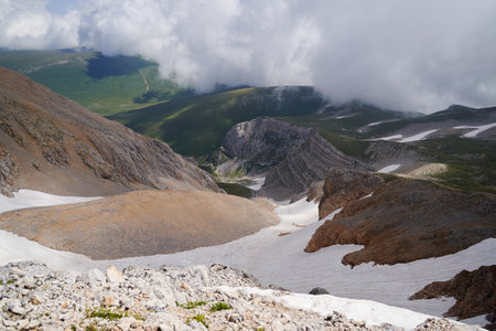 Epic view of the mountain gorge with glaciers, covered with clouds.の写真素材