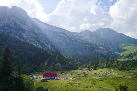 Beautiful landscape with a tent camping at the foot of the mountains.の写真素材