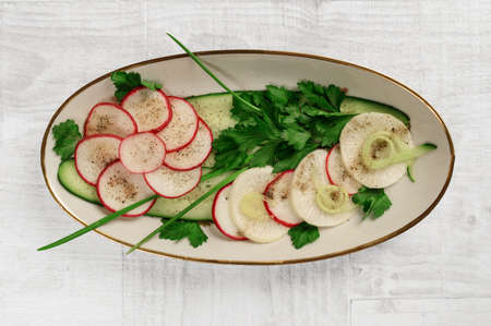 radish salad with greens on a platter. the view from the topの写真素材
