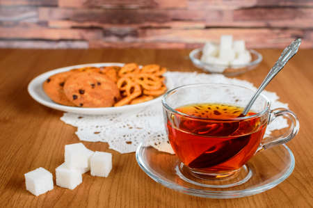 rich tea in a glass Cup. cookies and refined sugarの写真素材