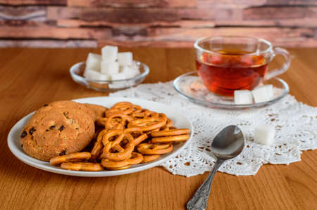 rich tea in a glass Cup. cookies and refined sugar on the lace napkinの写真素材