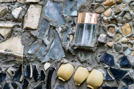 roughly uneven background. glass and ceramics in the wallの写真素材