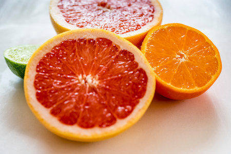 Colorful half citrus fruit, side view, closeup. Grapefruit, orange and lime fruit half, macro, horizontal.の写真素材