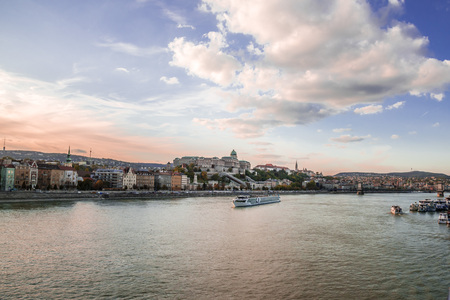 Panoramic city view at dusk from river Danube, Budapest, Hungary. Cityscape across the river to the Chain Bridge and historic buildings on Buda hills.の写真素材