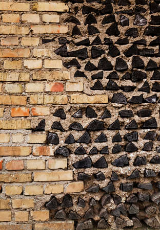 the building wall which is partially made of wooden logsの写真素材