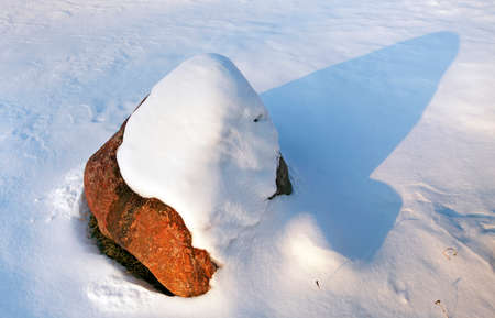 big stone on which lies snow after a blizzard past .の写真素材