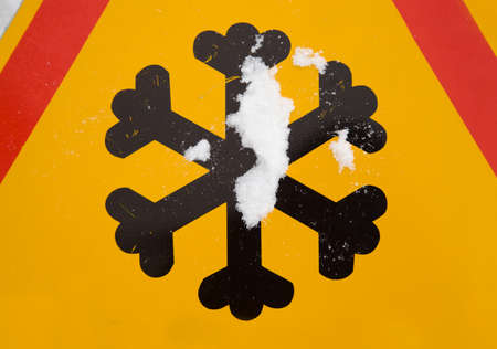 the road sign photographed by a close up designating the slippery roadの写真素材