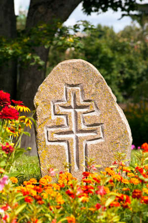 a stone with a cross, used as a monument.の写真素材