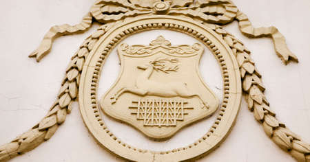 the ancient municipal coat of arms of Grodno  located on one of ancient buildings of the cityの写真素材