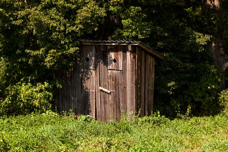 photographed close-up of a wooden toilet, located in the parkの写真素材