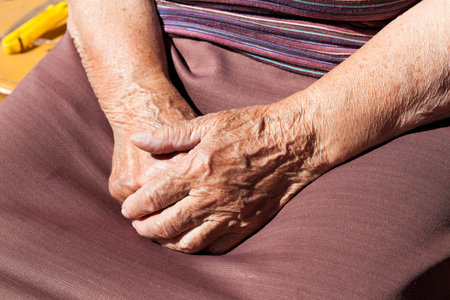 photographed closeup of an old woman. hands folded togetherの写真素材