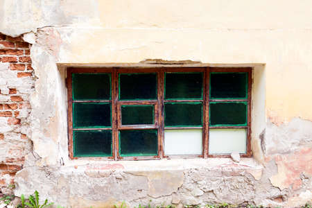 boarded up window in an old abandoned building, close-up,の写真素材