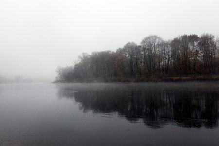 sunrise on the river during the late autumn, mist, cloudy, a small depth of fieldの写真素材