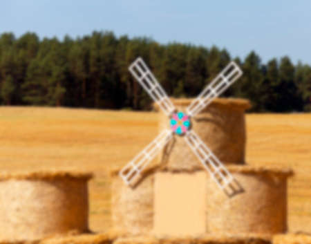 Agricultural field on which were left lying Straw Haystacks after the wheat harvest, grain field, farming and organic foods, autumn season, defocusの写真素材