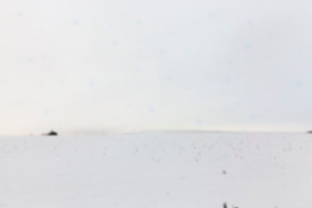 farm field photographed in winter, covered with white snow, defocus