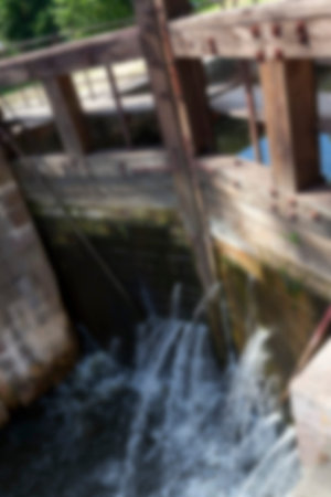 photographed close-up of the old wooden dam, which formed holes flowing dam defocus