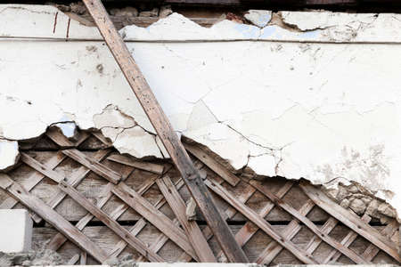 photographed close-up of the old wooden building, which began to collapse, visible ceiling grilleの写真素材