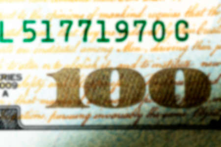 one hundred US dollars - photographed close-up of American paper money worth one hundred dollars, the new American bill, defocusの写真素材