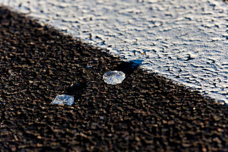 glass left on the pavement after the commission of a road accident, a new way of black glass on the focus, little depth of field, close-upの写真素材
