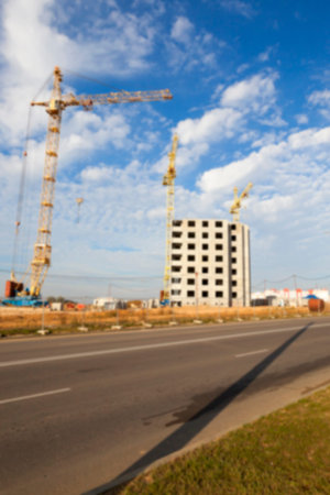 photographed close-up construction cranes during construction of a new multi-storey apartment...