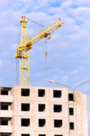 photographed close-up construction cranes during construction of a new multi-storey apartment...