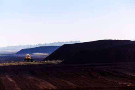 bog and the field on which the production is carried out in black peat mining, industry, defocus, old tractorの写真素材