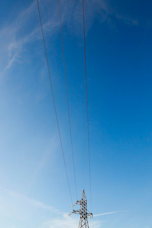 photographed electric poles situated in the daytime, industrial buildings