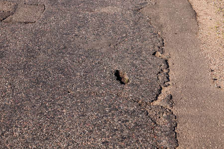 photographed close-up part of the road that has been spoiled with timeの写真素材