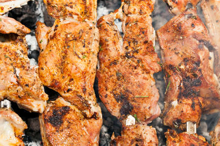 photographed close-up of pork meat pieces while cooking barbecueの写真素材