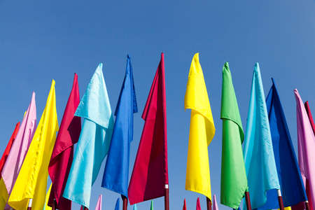 flags used to decorate the city during the festivities. Photo on a background of blue skyの写真素材