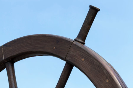 photographed close-up part of the wheel of a large ship on a background of blue sky