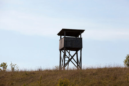 wooden tower, located on a hill. The photo was taken in cloudy weather