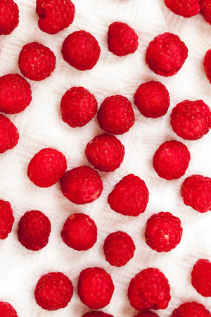 harvest red ripe wild raspberries. The photo was taken close-up, small depth of field. Berries are...