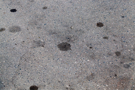 paved road on which there were traces of engine oil leaked from the carの写真素材