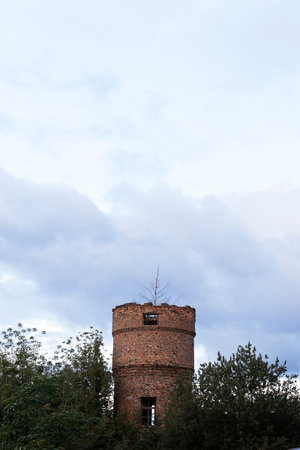 close-up photograph of an old water tower, made of bricks. blue skyの写真素材