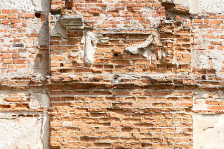 a photograph of the wall of an old fortress made of red brick. Photo made of a ruined buildingの写真素材