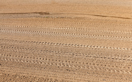 Tractor cultivating fieldPlowed farmland in the spring season. Preparing the soil for sowing. Photo close-up, top view at spring,aerial viewの写真素材